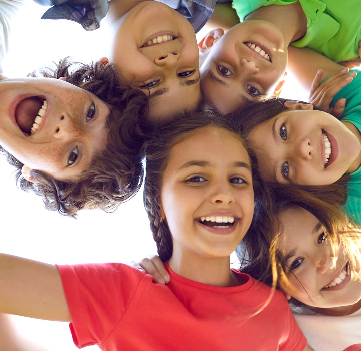 Group of smiling children in a circle.